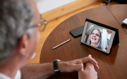 Two peop;le chating over a face to face conection on a laptop computer